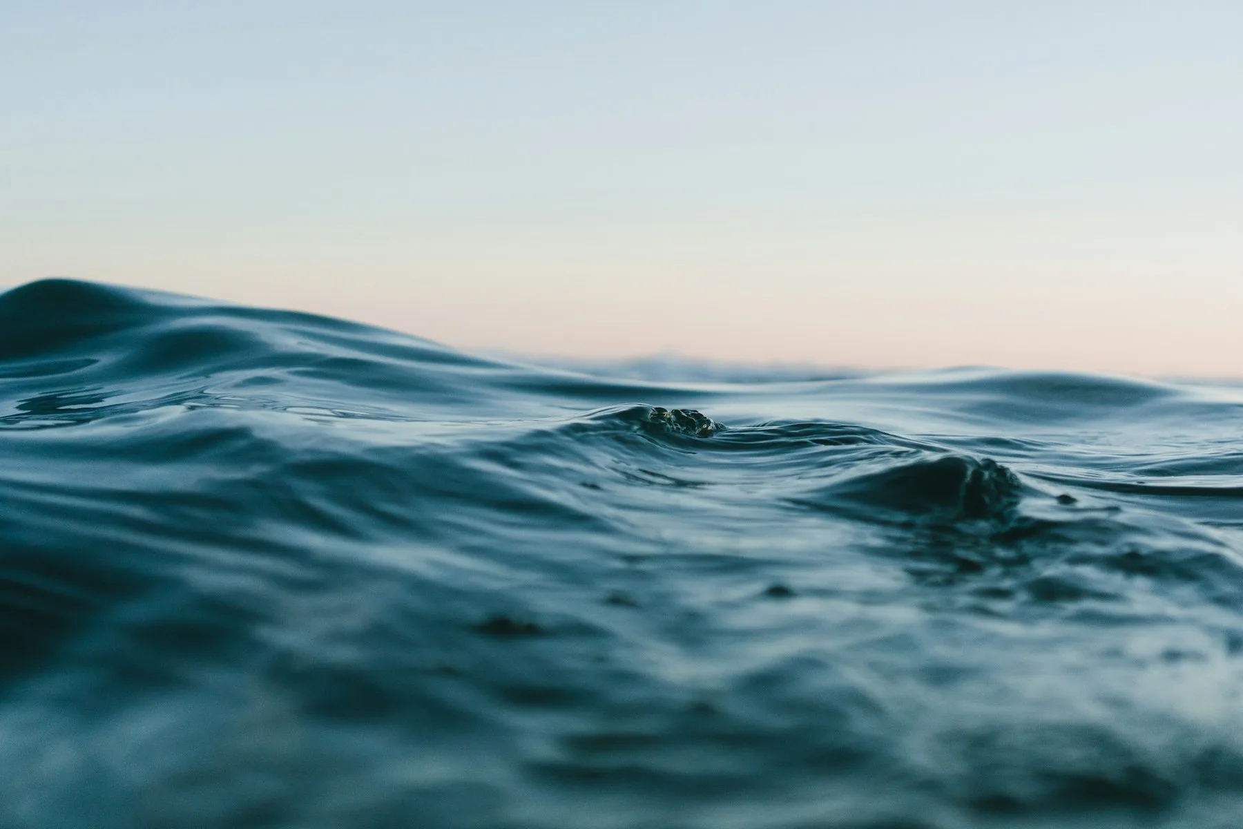 Open ocean swell beneath a pale sky