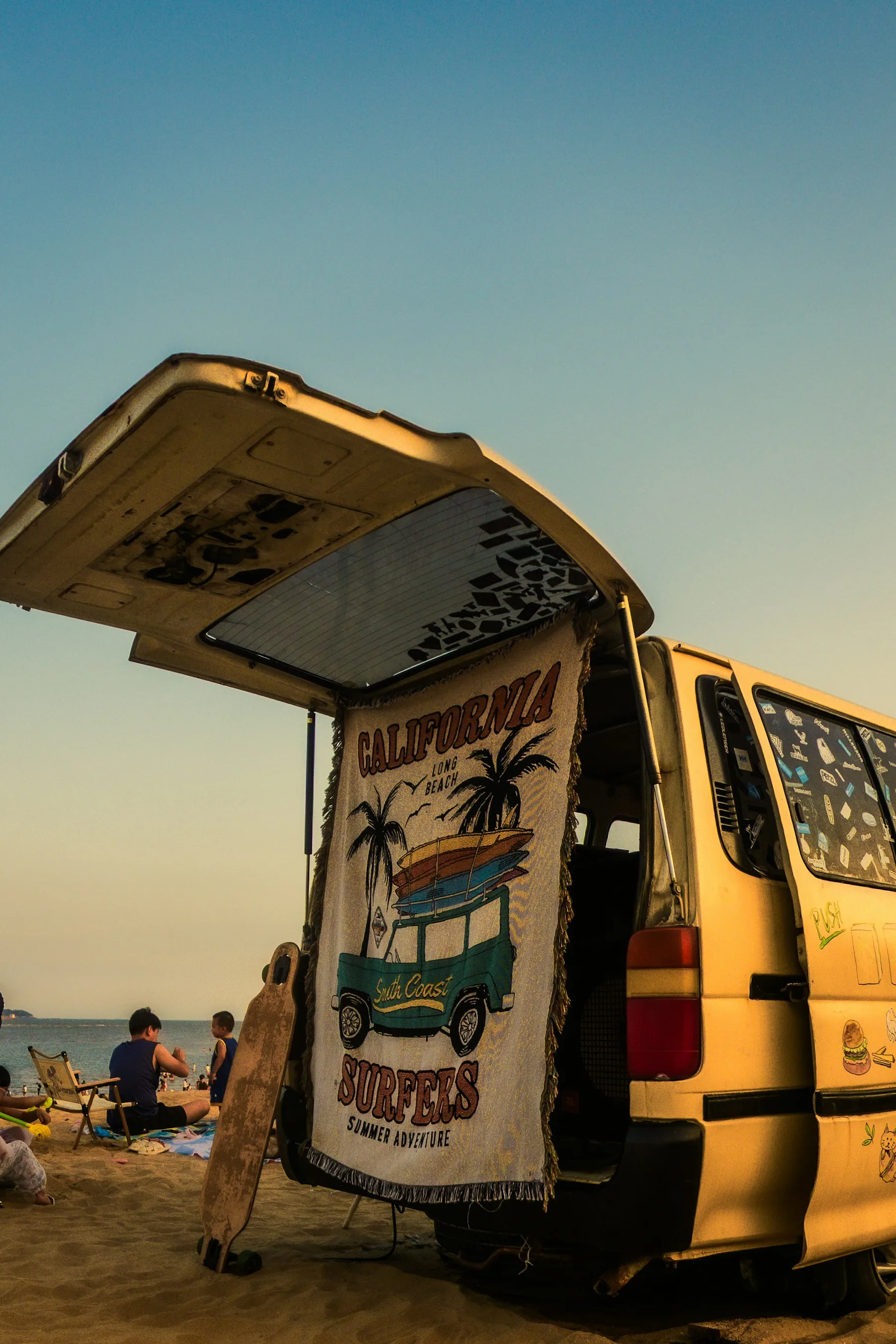 Yellow surf van parked beside the beach